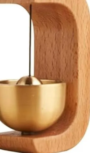 Wooden doorbell with a brass bell