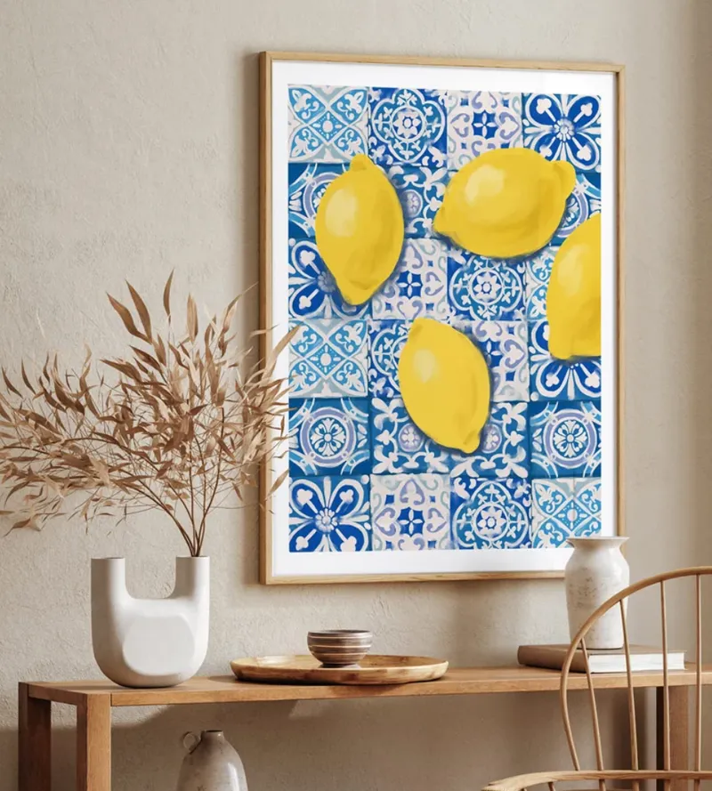 Yellow lemons on blue Moroccan tiles, framed above a console