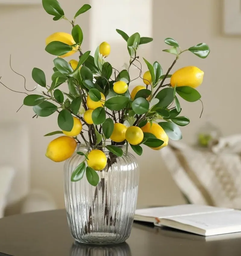 Three faux lemon branches in a ribbed glass vase