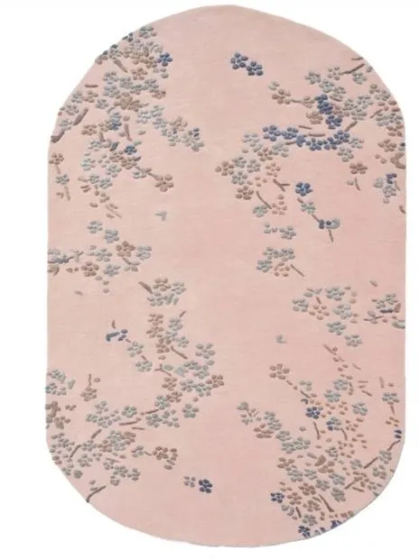 Pink oval rug with a floral pattern