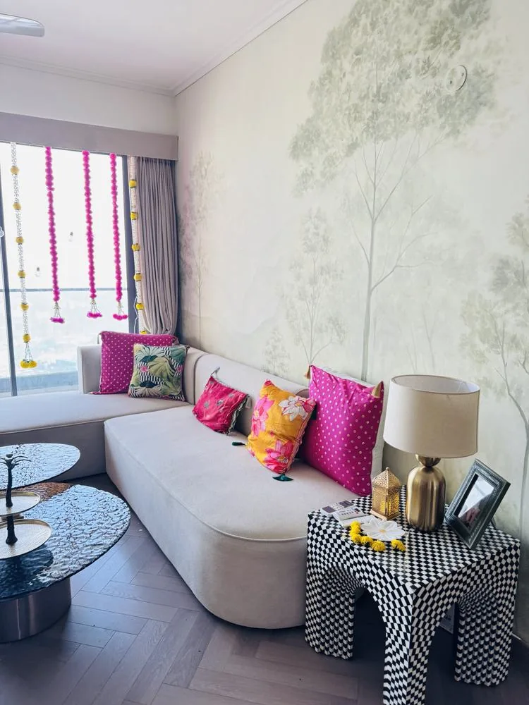 Sofa corner by day with pink and lotus cushions and a checkered side table
