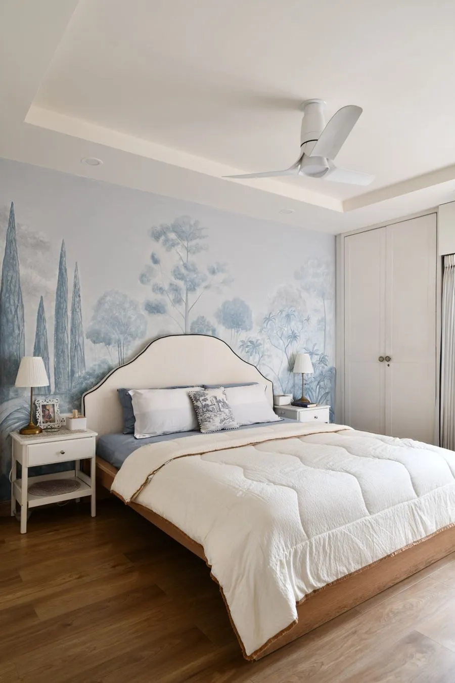 Bedroom with a hand-painted blue forest mural