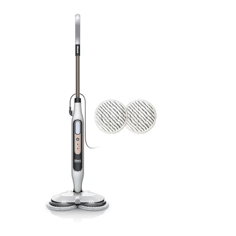 A grey Shark steam mop standing upright, with two spare round scrub pads beside it