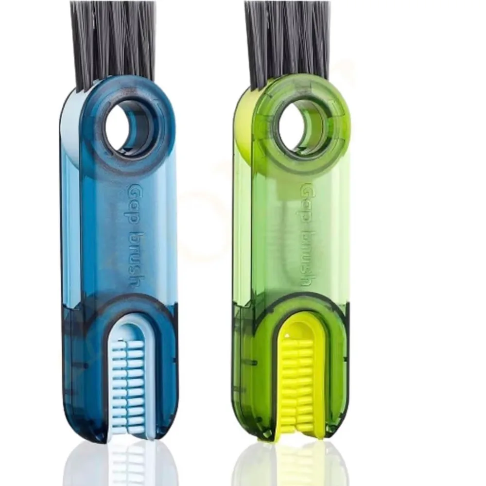 Two translucent 3-in-1 gap brushes, one blue and one green, each with bristles at the top and a groove scrubber at the base