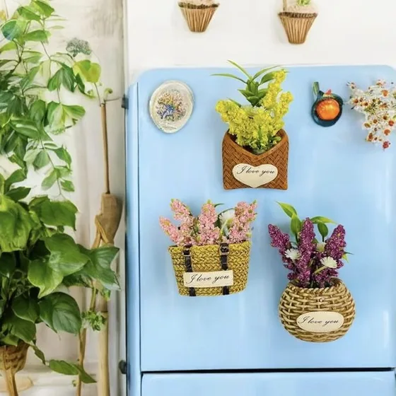 Woven basket magnets filled with faux flowers on a pale blue fridge
