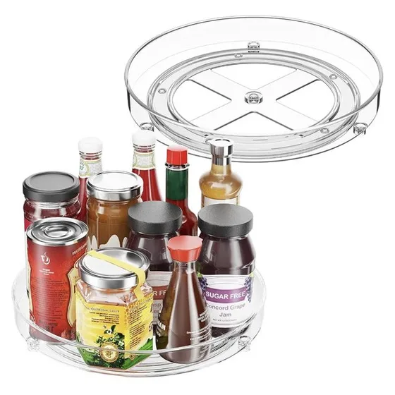 A clear acrylic lazy Susan turntable, shown empty and loaded with sauce bottles and jars