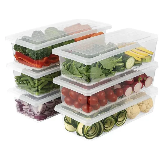 Stacked clear fridge boxes with lids, holding spinach, tomatoes, peppers and sliced cucumber