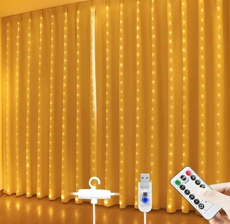 A wall of warm curtain lights running down behind sheer curtains, with its USB plug, hook and remote