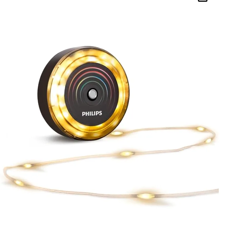A battery-powered fairy light disc with a fine wire strand of warm LEDs running out of it