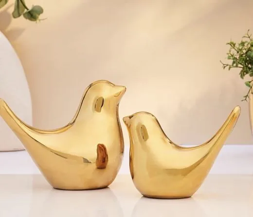 Two gold ceramic bird figurines