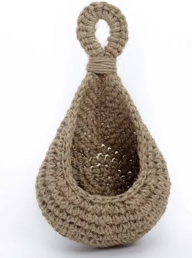 A crocheted jute hanging basket with a loop at the top