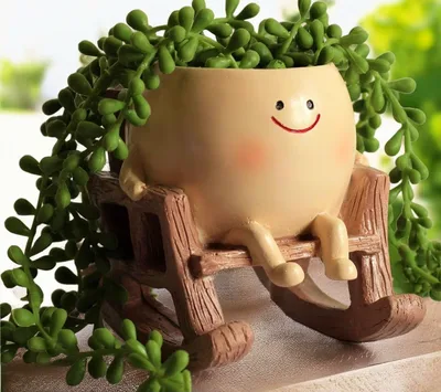 Smiling-face planter sitting on a little rocking chair