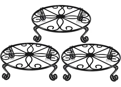 Three black round scrollwork metal pot stands
