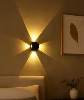 Black outdoor LED wall light casting light up and down