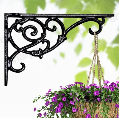 Black scrollwork wall bracket holding a hanging flower basket