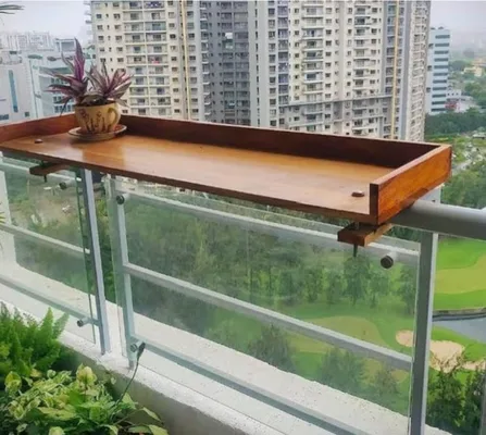 Wooden table hung on a balcony railing