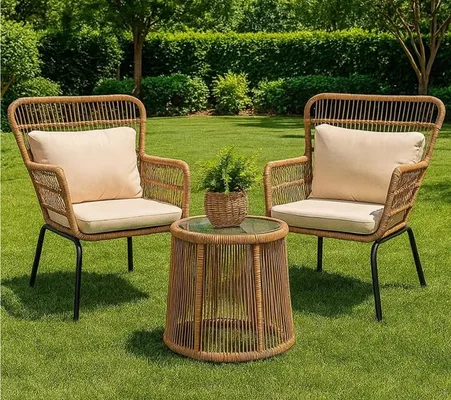 Woven rattan chairs with cushions and a round table