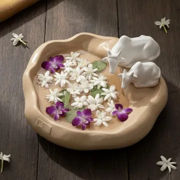 Ceramic urli with cow figurines