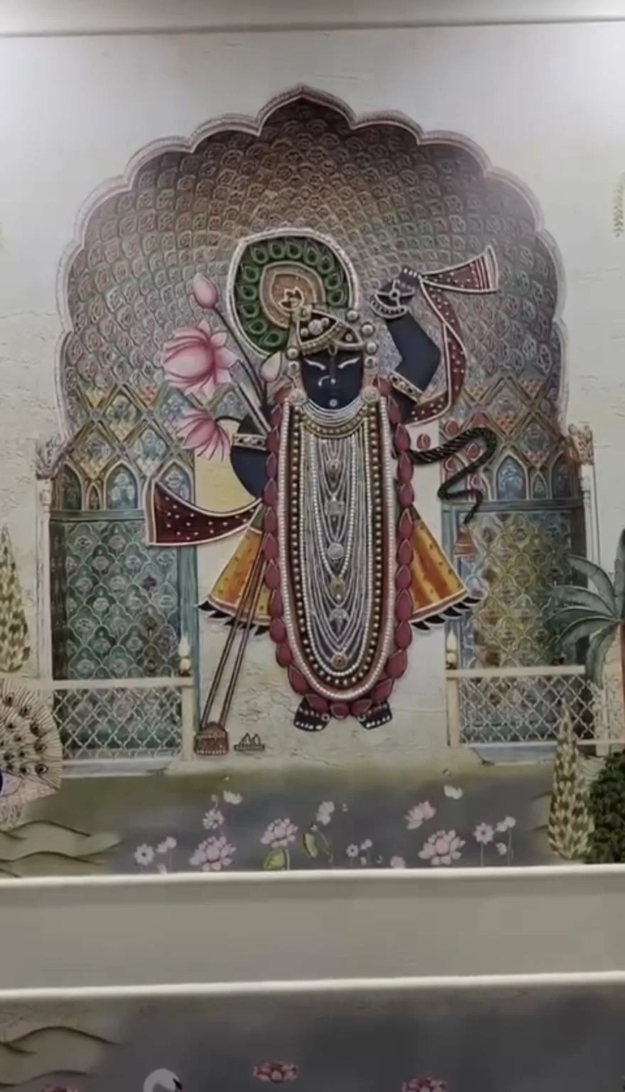 Shrinathji embroidered across a full wall panel with a scalloped arch, havelis and lotuses